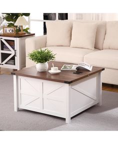 a living room with a white couch and coffee table