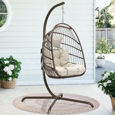 a brown swing chair sitting on top of a patio