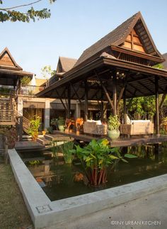 an outdoor living area with water and plants