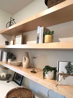 some shelves with plants and pictures on them