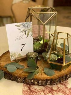 the table is set up with candles and greenery