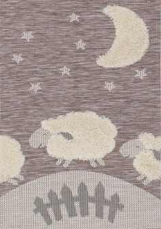 two sheep are standing in the middle of a rug with stars and moon on it