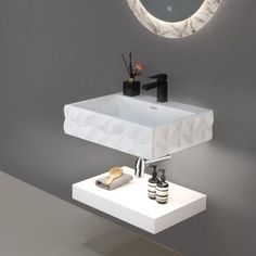 a bathroom sink sitting under a round mirror