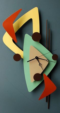 a clock made out of colored paper on a wall