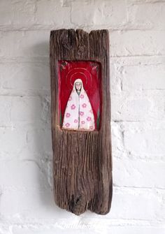 a wooden frame with an image of a woman in white and pink dress on it