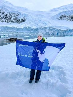 a person holding up a blue flag in the snow