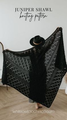 a woman holding up a black shawl with the words jumper shaw knitting pattern on it