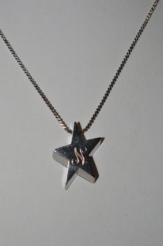 "DESCRIPTION:  Silver alloy star with the letter \"N\" engraved. Chain approximately 15\". Article      1050130 Color      Silver Material      Alloy Size              Total Length - approximately 16.5\" Pendant        3/4\" Shape        Quantity1 Origin     China - To see all the necklaces in my shop: http://www.etsy.com/shop/ReflectionOtherSide/search?search_query=necklaces SHIPPING: I ship quickly but holidays and Sunday prevent next day mailing so please if you place an order on those days allow me an extra day to get your items in the mail. All items I ship are either in puff pad envelopes or gift boxed to prevent damage to the item. SUGGESTIONS: I welcome any comments, questions or suggestions. I am always looking to improve my store and assist my guests any way I can. OTHER SHOP(S): N Necklace, The Letter N, Silver Star Necklace, Star Necklace Silver, Letter N, Those Days, Silver Material, Silver Stars, Star Necklace