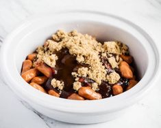 a white bowl filled with food on top of a table