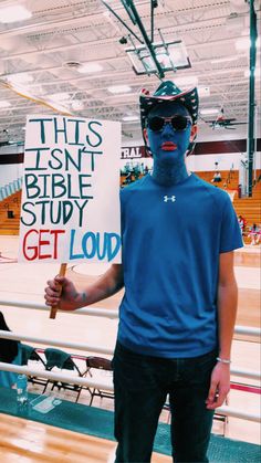 a man holding a sign that reads this isn't the bible study get loud