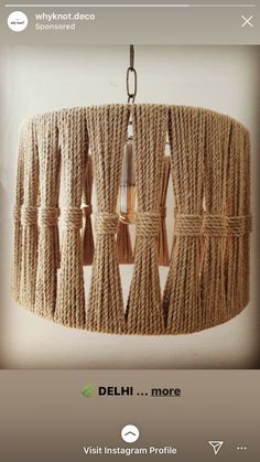 a chandelier made out of jute rope with lightshades hanging from it