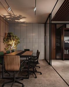 a table with chairs and a potted plant in the middle of it on top of a carpeted floor