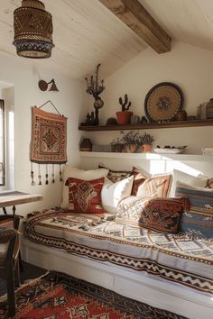 a bed sitting under a window next to a wooden shelf filled with vases and potted plants