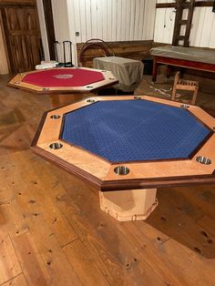 two tables with blue cloth on them in a room filled with wooden chairs and other furniture