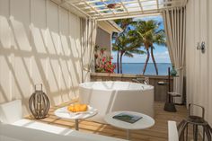 a white bath tub sitting on top of a wooden floor