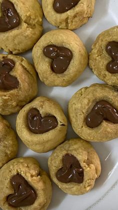 chocolate chip cookies on a white plate with hearts in the middle and one cookie missing