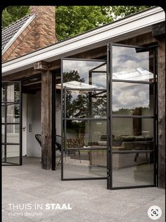 an open glass door on the outside of a house