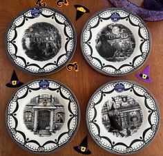 three plates with black and white designs on them sitting on a table next to halloween decorations