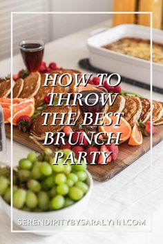 the best brunch party food is served on a cutting board with grapes and oranges