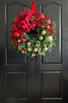 a christmas wreath hanging on the front door