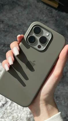 a woman's hand holding up an iphone case