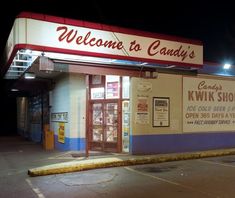 the front of a candy shop at night