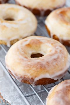 glazed donuts sitting on top of a cooling rack