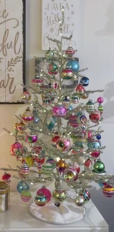 a white christmas tree with ornaments on it