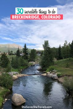 a river running through a lush green forest filled with rocks and pine trees in the background