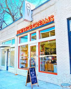 the entrance to an ice cream shop on a city street