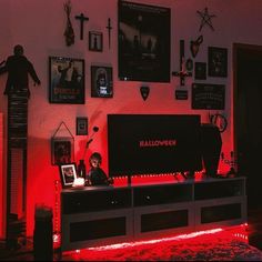 a living room filled with furniture and pictures on the wall above it is a red light