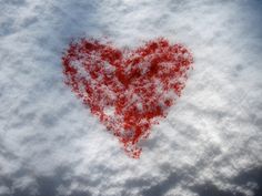 a red heart shaped object floating in the air