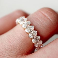 a woman's hand with a diamond ring on it