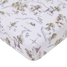 a white crib sheet with trees and animals printed on the top, along with words that spell out where to go