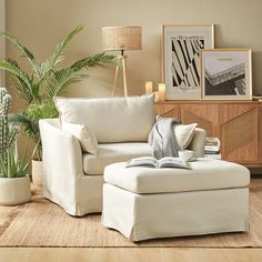 a living room with a couch, chair and potted plant on the side table