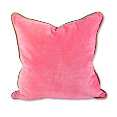 a pink pillow with brown piping on the front and back, against a white background