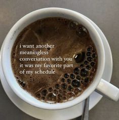 a cup of coffee with a poem written on the top and bottom in front of it