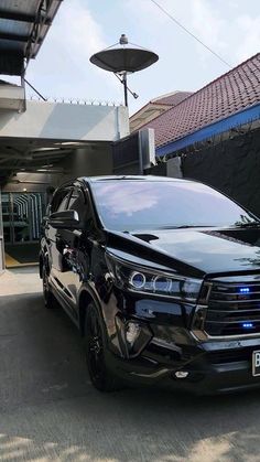 a black suv parked in front of a building