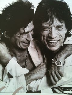 two men are hugging each other and smiling