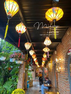 lanterns hanging from the ceiling in an outdoor restaurant