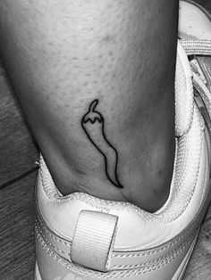 a black and white photo of a person's foot with a tattoo on it