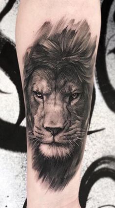 a black and white lion tattoo on the arm