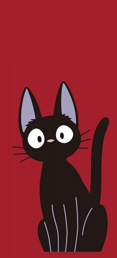 a black cat sitting on top of a red background