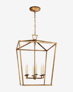 a brass lantern with four candles hanging from the ceiling