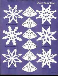 paper snowflakes are arranged on a blue background