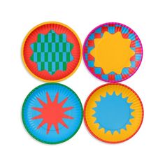 four paper plates with different designs on them