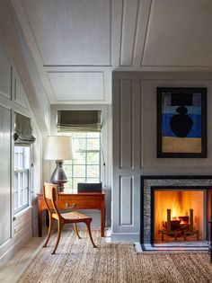 a living room filled with furniture and a fire place next to a painting on the wall