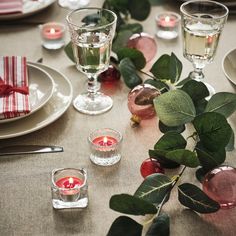 the table is set with candles and place settings