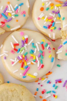 white frosted donuts with sprinkles on them