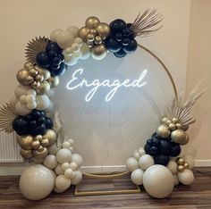 a mirror that has balloons in the shape of palm leaves and an engaged sign on it